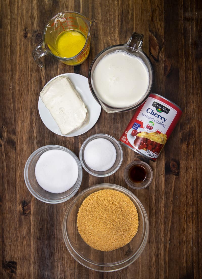 graham cracker crumbs, salted butter, cream cheese, sugar, heavy whipping cream, vanilla extract, cherry pie filling.