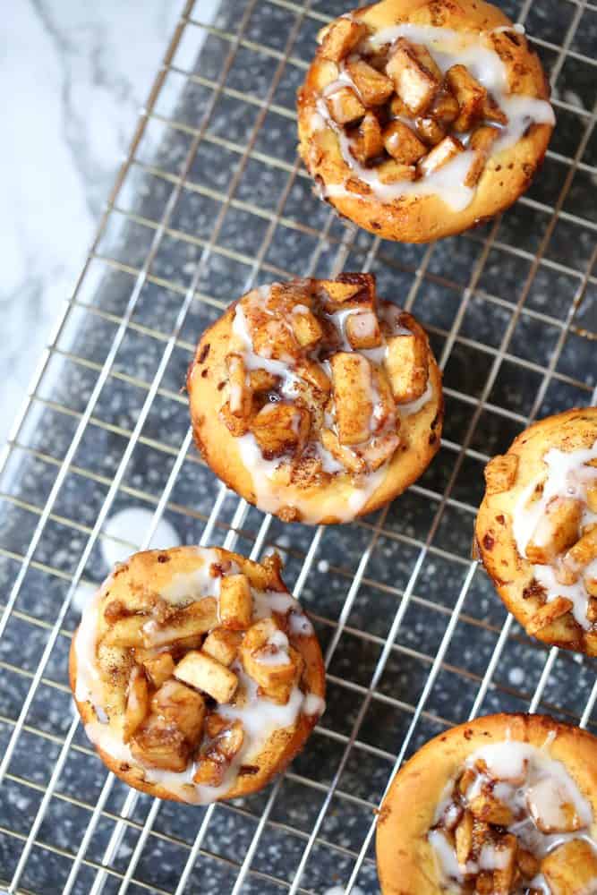 icing drizzled on cinnamon roll apple pie cups