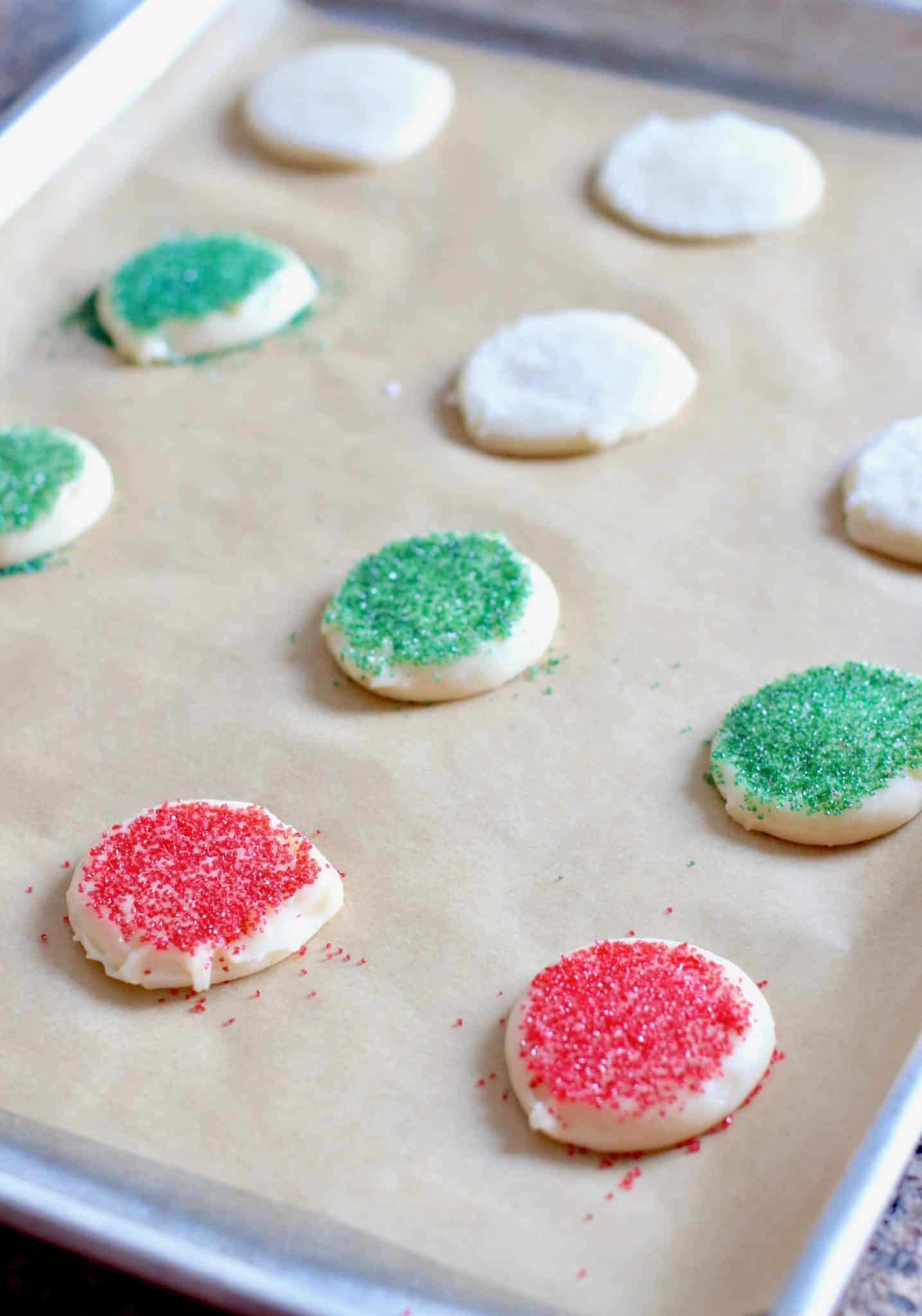 baking sheet with unbaked Christmas sugar cookies.