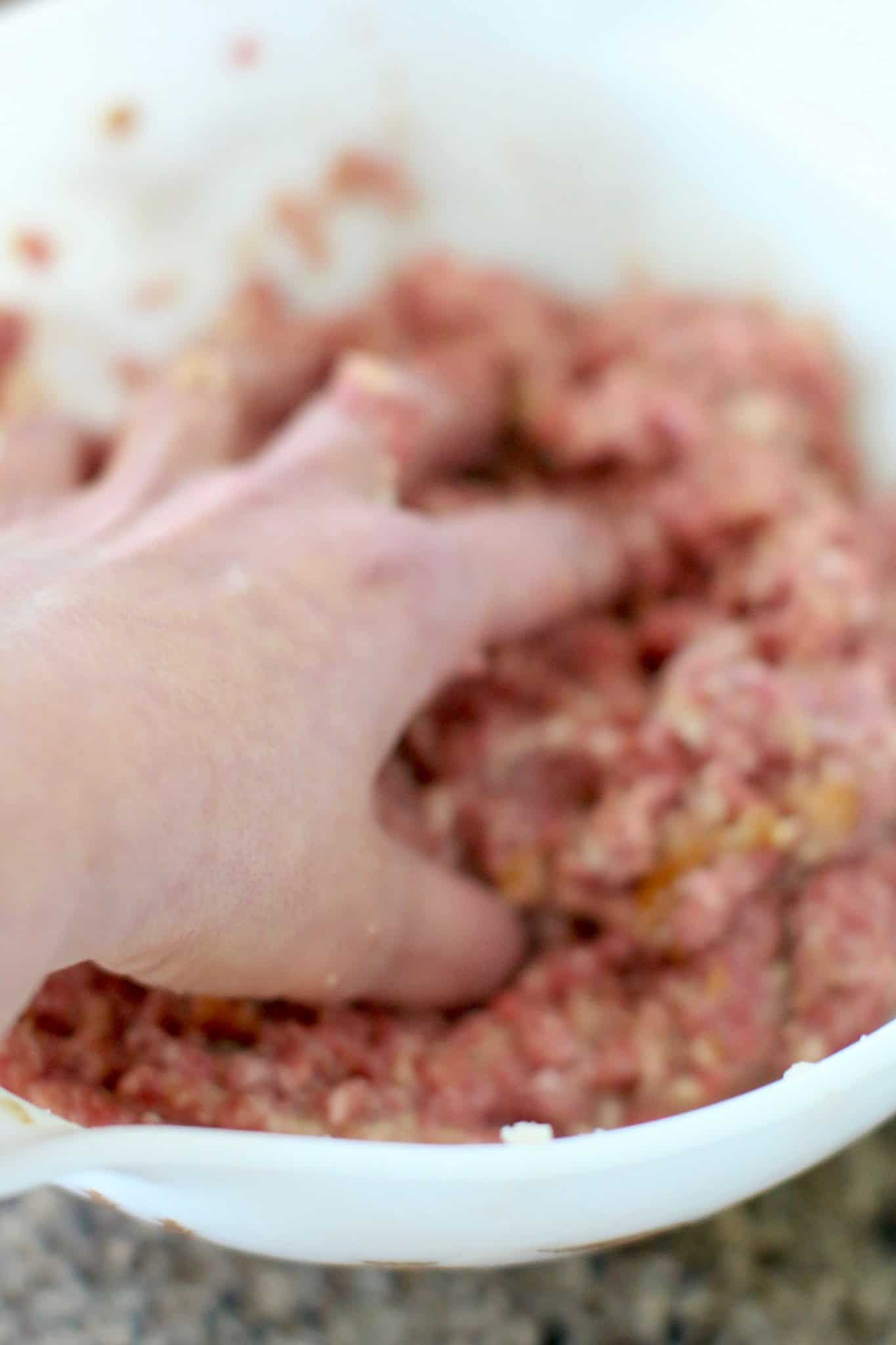 hand mixing meatloaf mixture.
