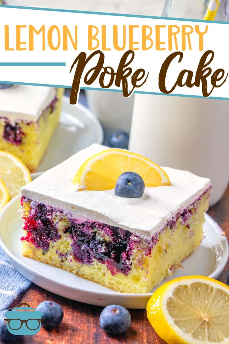 Lemon Blueberry Poke Cake recipe from The Country Cook, pictured, slice on a plate, topped with a fresh lemon slice and a blueberry