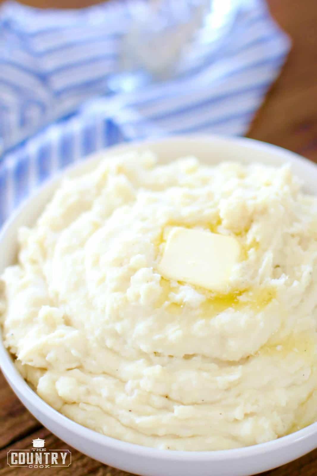 bowl of mashed potatoes with melted butter.