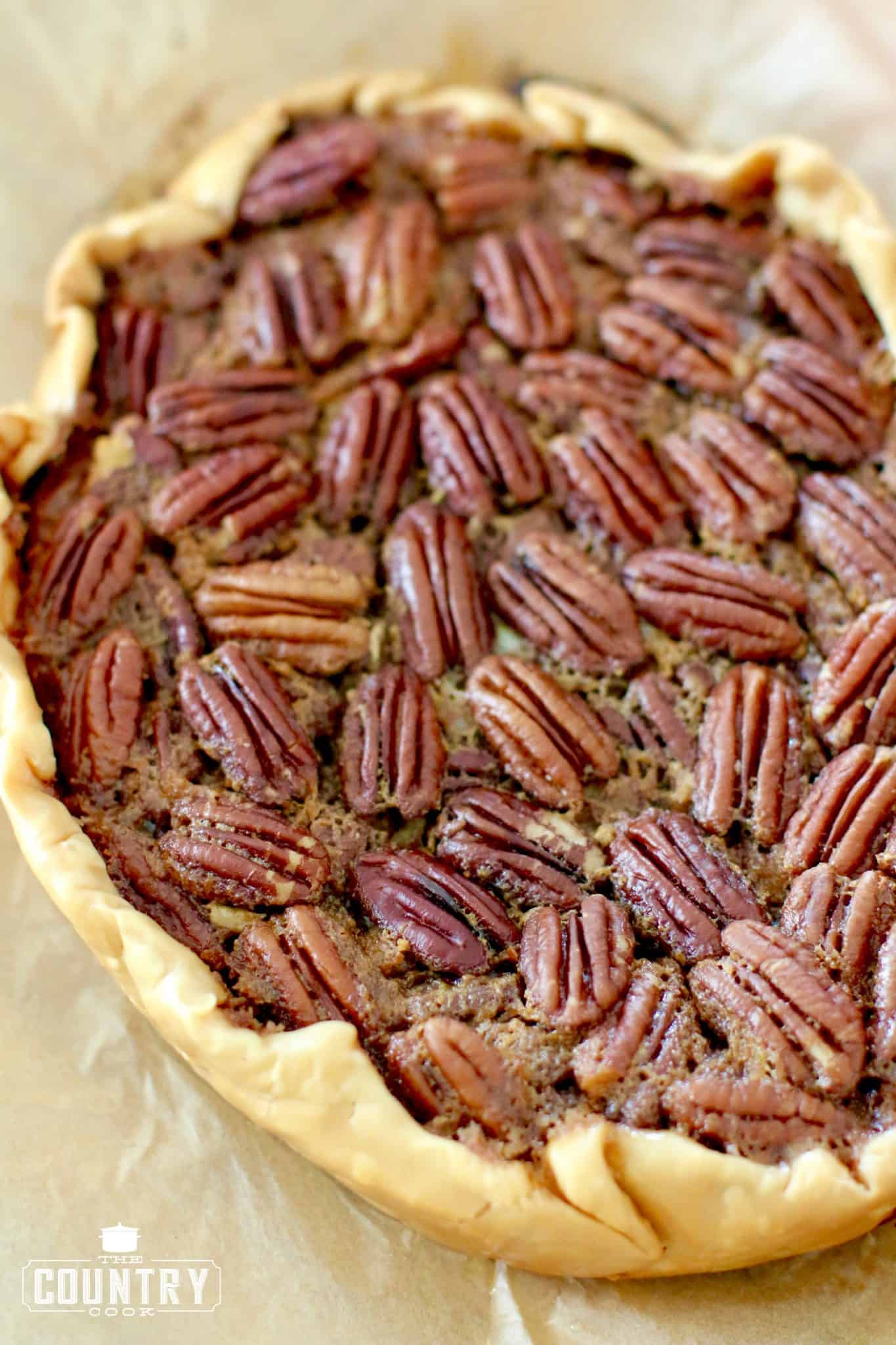 completely cooled pecan pie on top of brown parchment paper. 