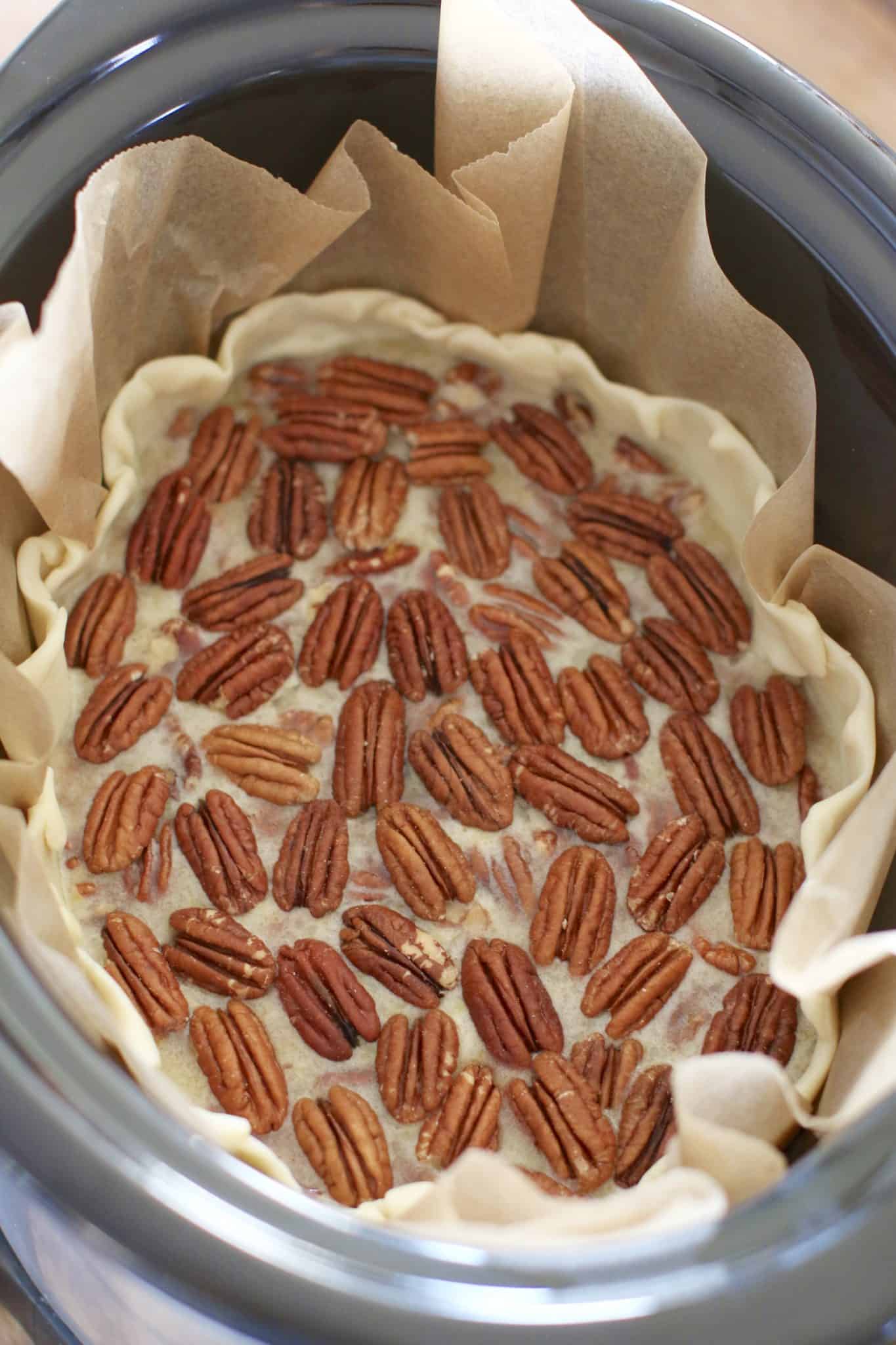 arranged pecans on top of pecan pie filling.