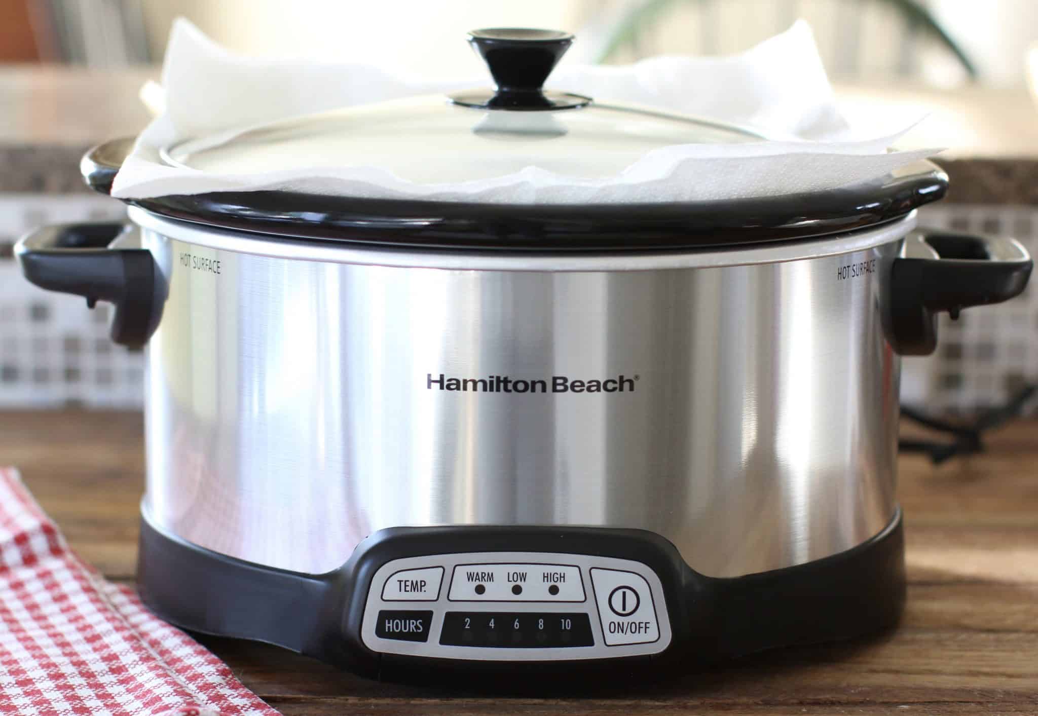 Hamilton Beach slow cooker shown with the lid on and a paper towel under the lid. 
