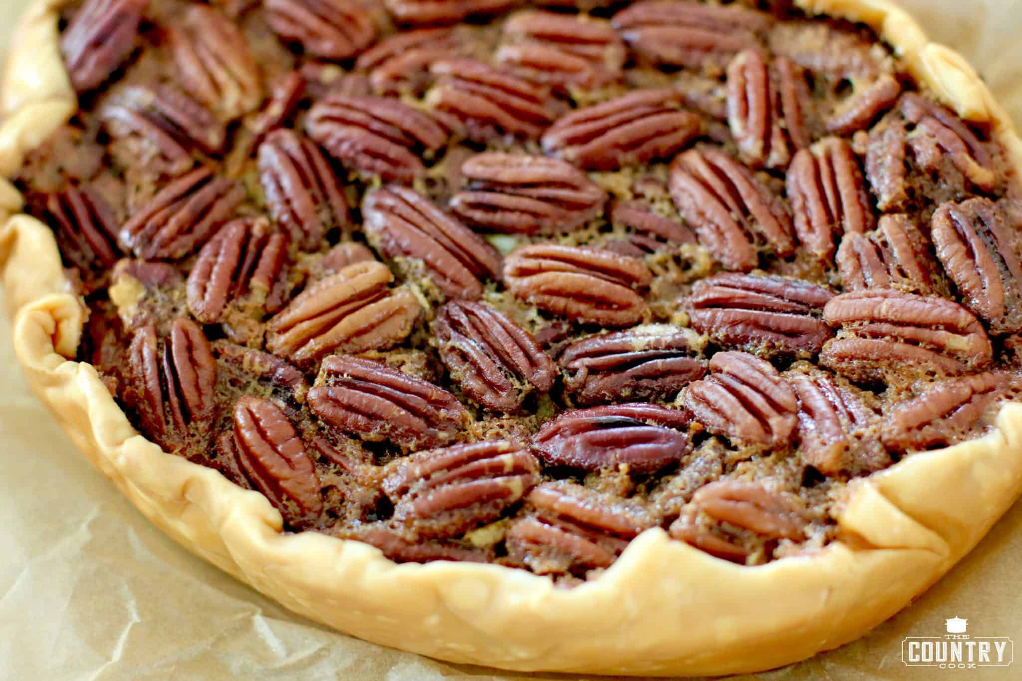 slow cooker pecan pie on parchment paper with refrigerated pie crust.