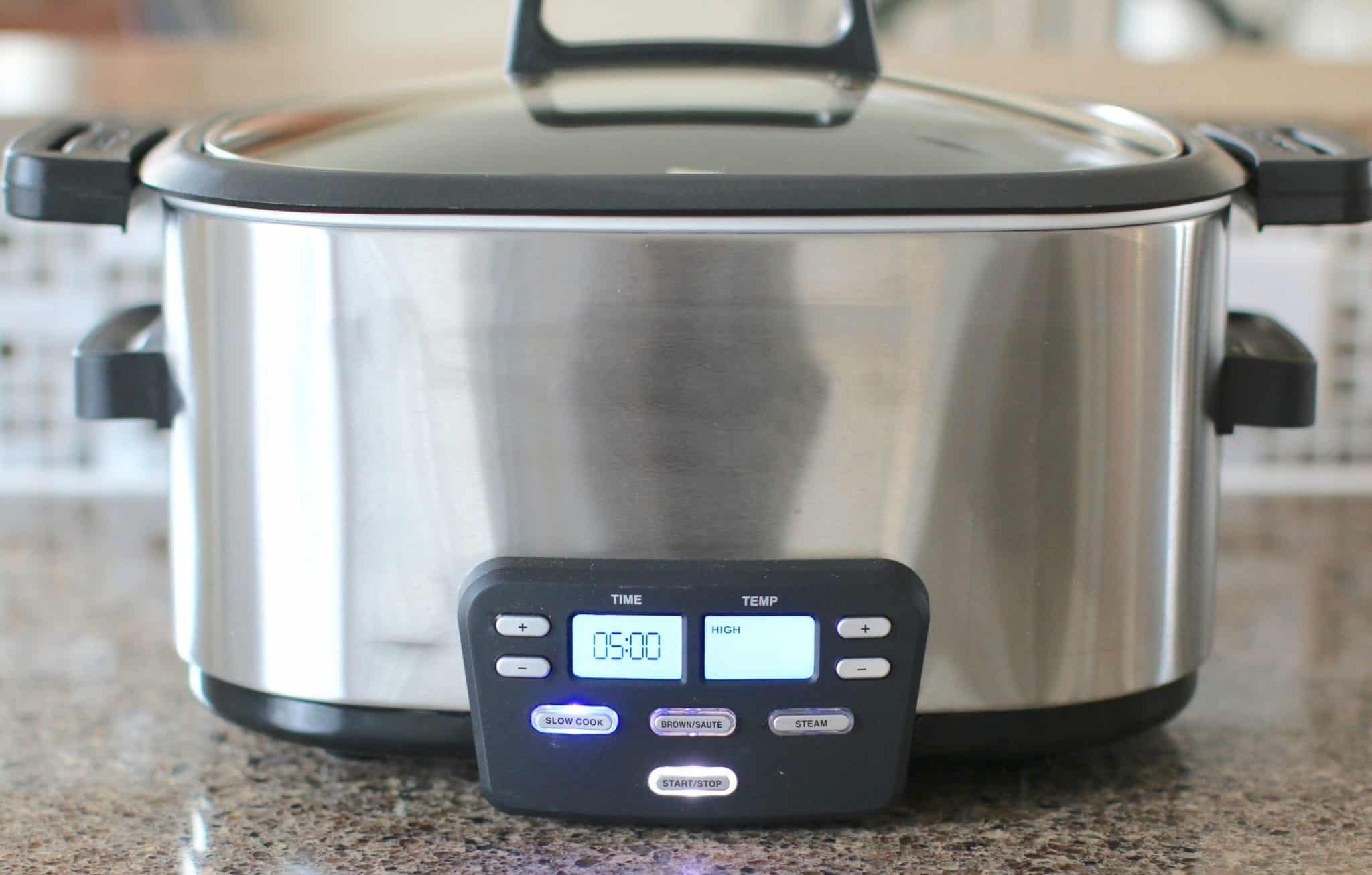 covered slow cooker with a digital display showing a 5 hour cooking time.