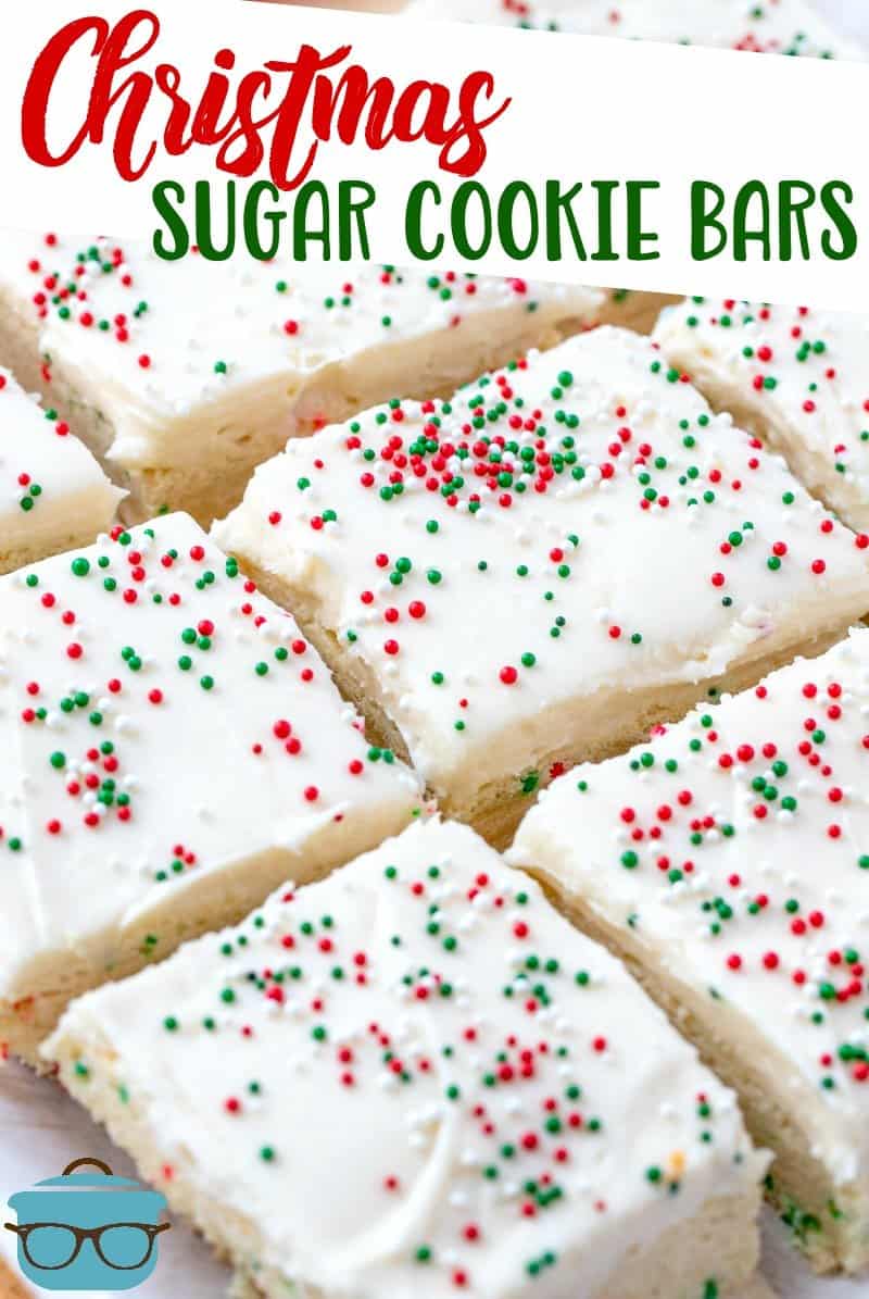 Homemade Christmas Sugar Cookie Bars recipe from The Country Cook. Sugar Cookie Bars shown cut out and laying next to each other on parchment paper. 