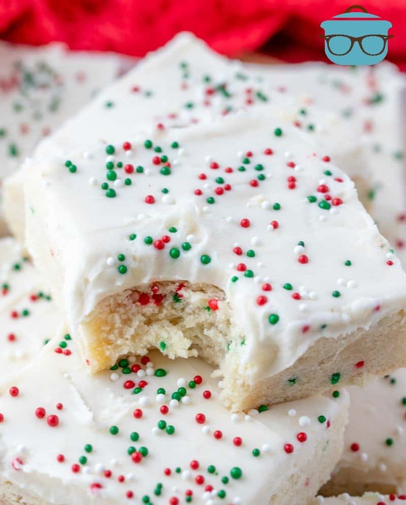 Holiday Christmas Sugar Cookie Bars, stacked with a bite taken out of one bar.