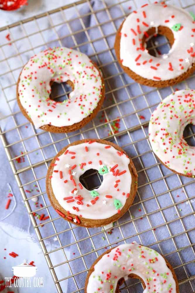 Gingerbread Doughnuts with Frosting shown on a wire cooling rack.