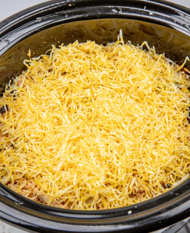 shredded cheese on top of chicken and rice mixture.