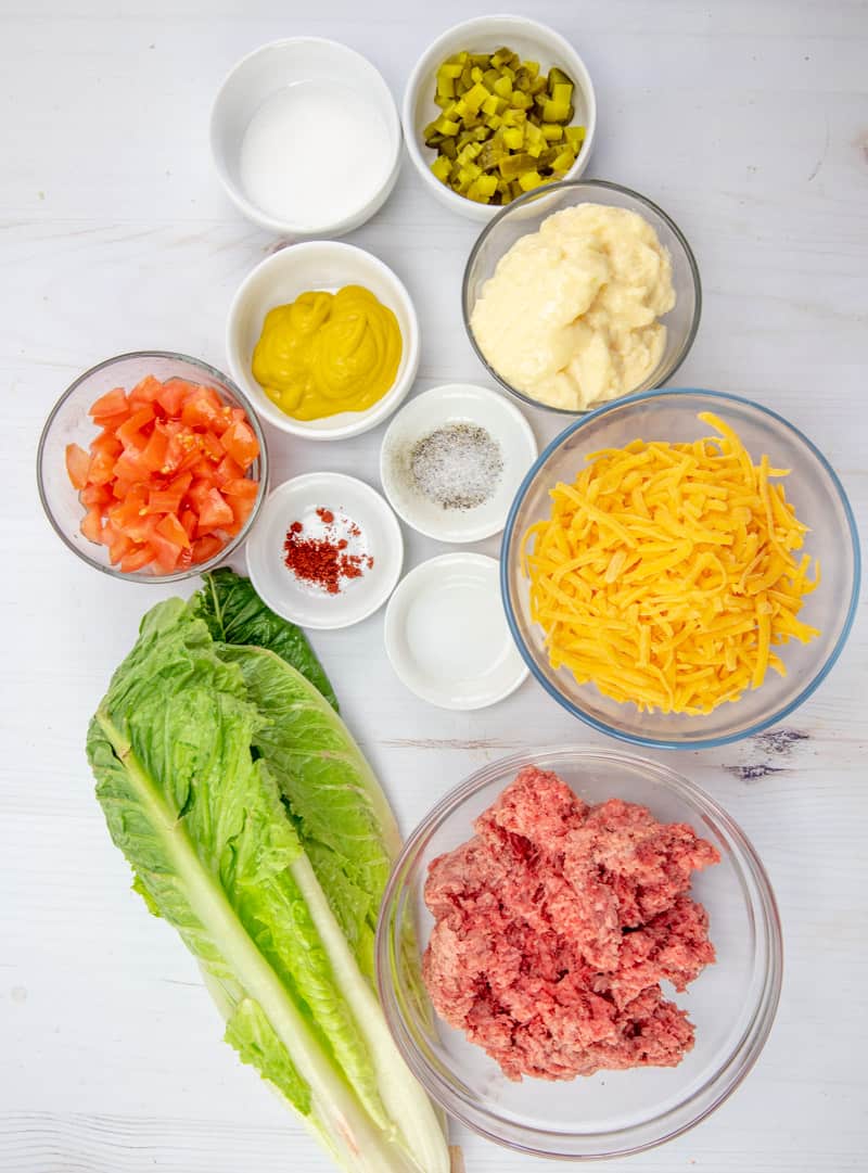ingredients needed: ground beef, salt, pepper, 1 head romaine lettuce, diced tomatoes, shredded cheddar cheese, diced dill pickles, ingredients for thousand island dressing.