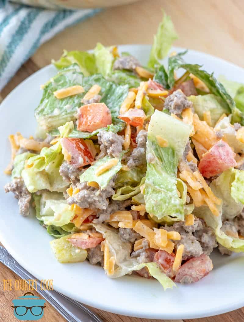 Cheeseburger Salad shown on a white plate. .