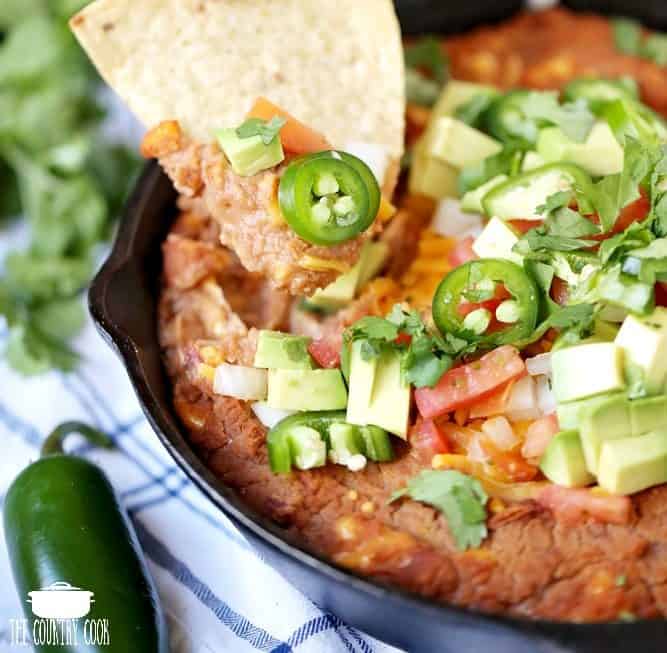 Easy Refried Bean Skillet Dip with tortilla chip