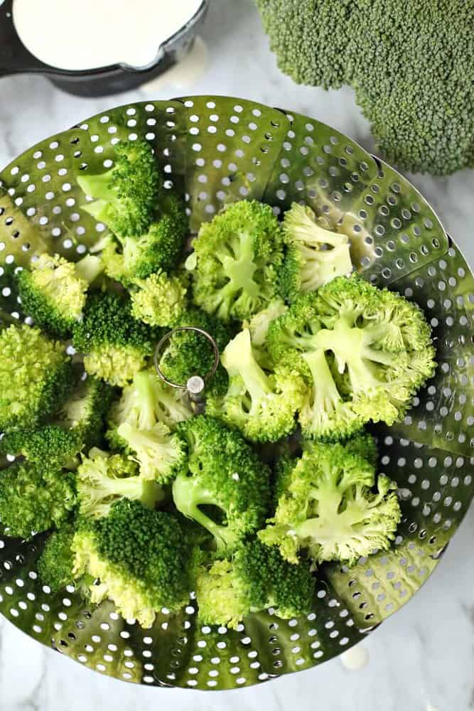 broccoli florets in a steamer basket. 