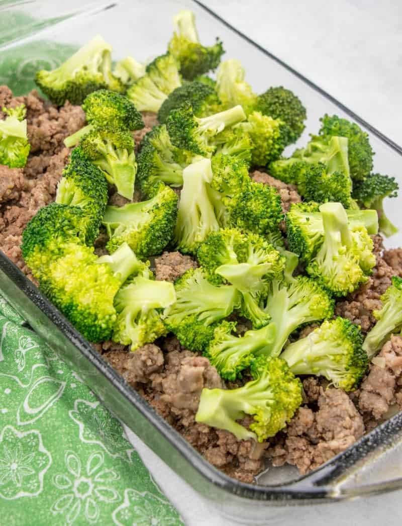 cooked sausage, ground beef, broccoli and cream sauce in a 9x13 baking dish.