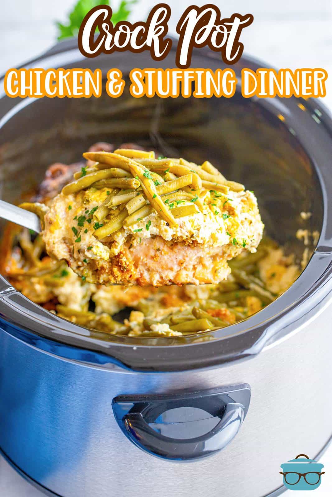 a spoon holding up a serving of chicken and stuffing over a slow cooker. 