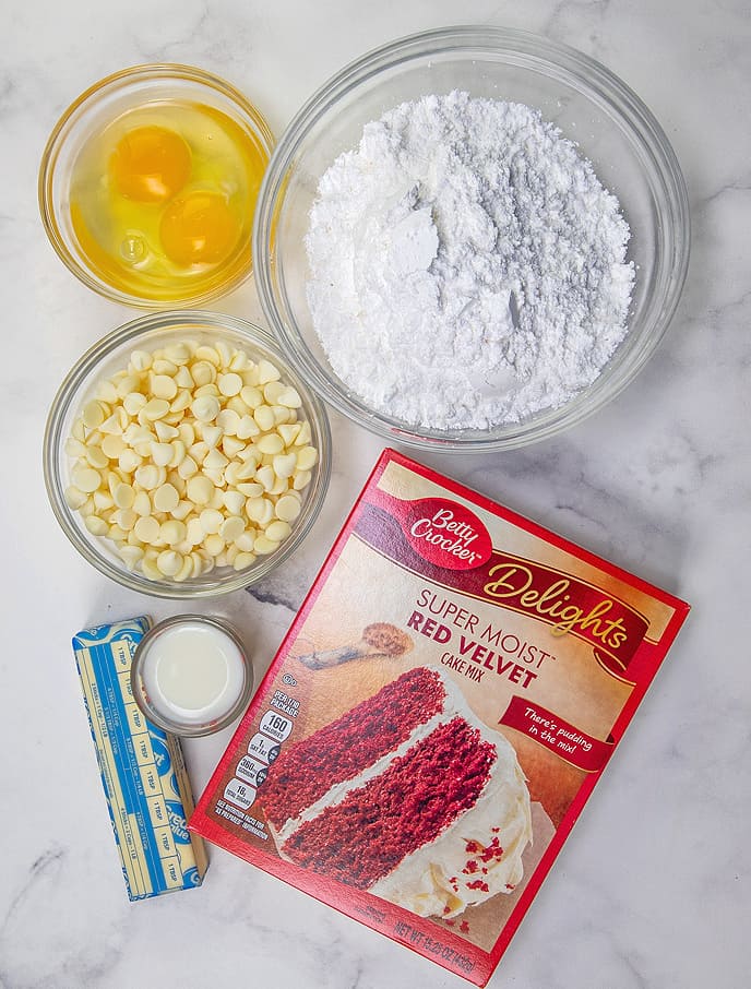 red velvet cake mix, unsalted butter, large eggs, white chocolate chips, powdered sugar, milk.
