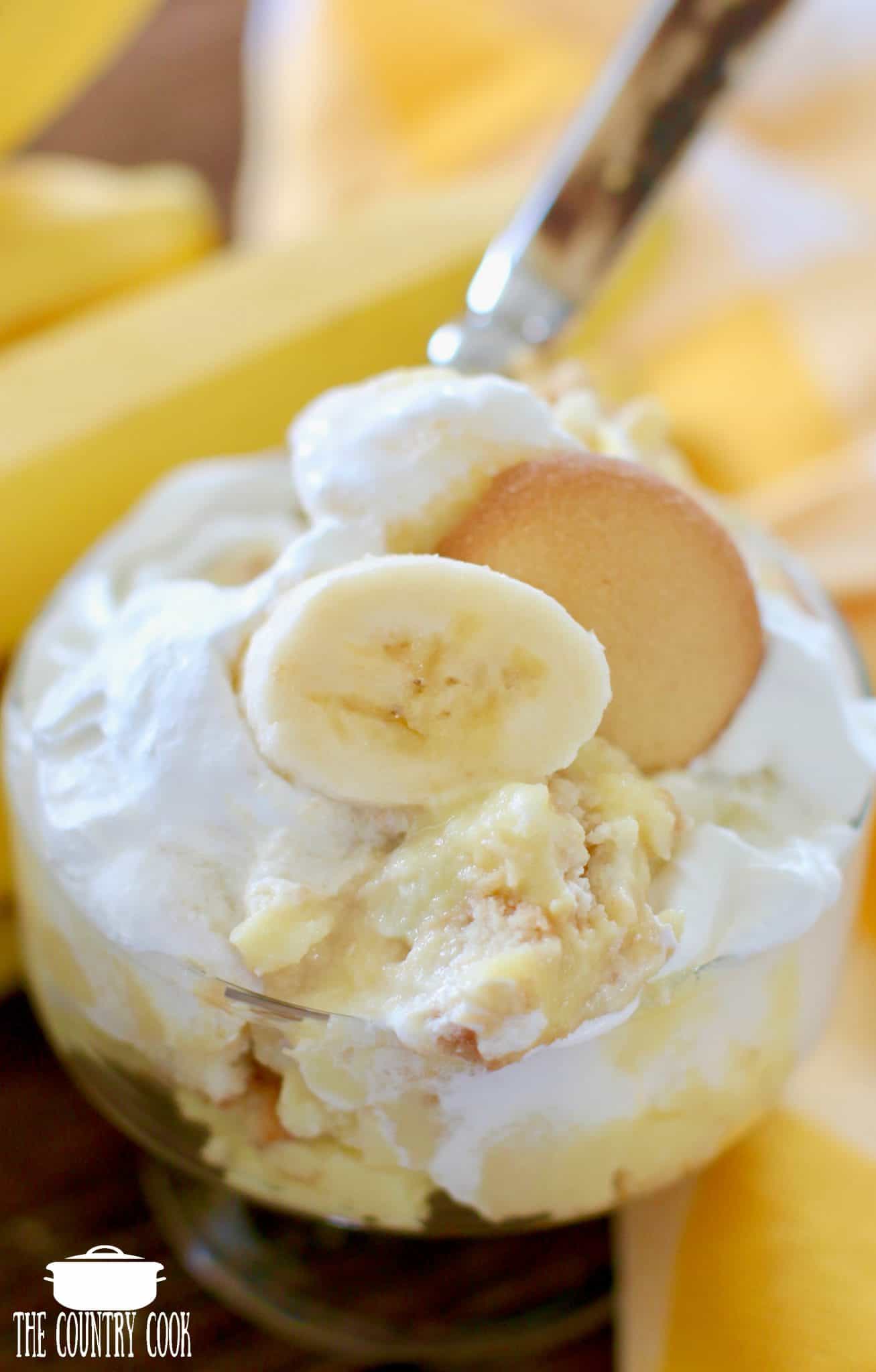 overhead photo of a serving of healthier banana pudding in a footed glass dessert dish. 