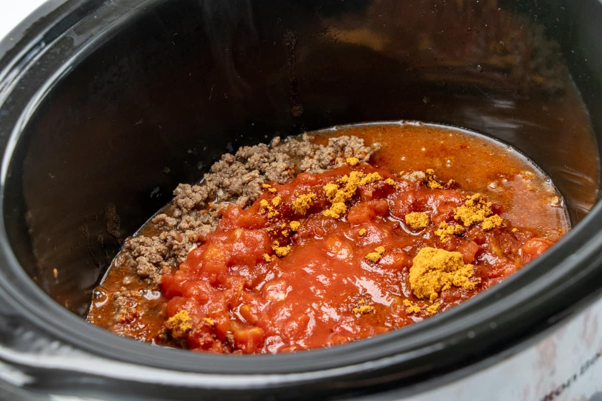 ground beef, diced tomatoes, water and taco seasoning in a slow cooker.