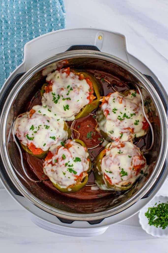 melted cheese on top of stuffed peppers inside instant pot