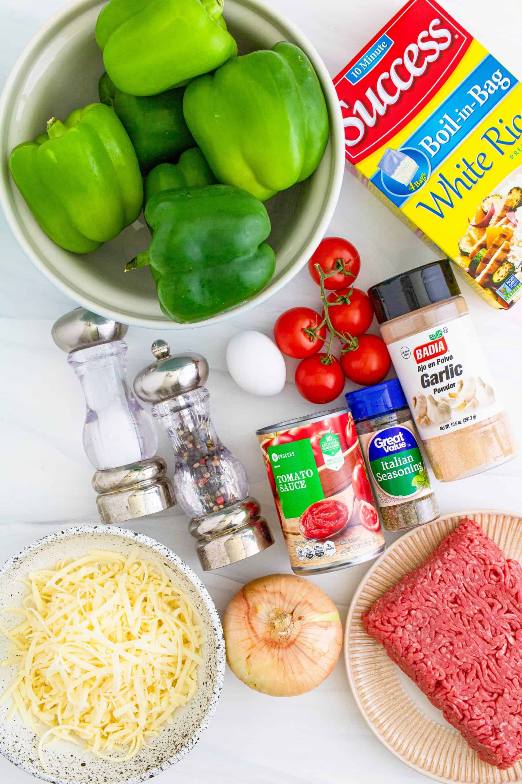 Instant Pot Stuffed Peppers ingredients: green bell peppers, onion, tomatoes, extra lean ground beef, boil-in-bag white rice, large egg, salt and pepper, Italian seasoning, garlic powder, tomato sauce, shredded mozzarella cheese
