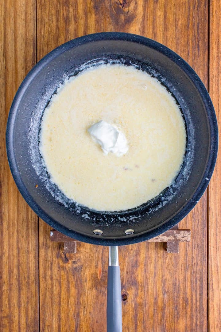 a dollop of sour cream in heavy cream and bacon fat in a skillet. 