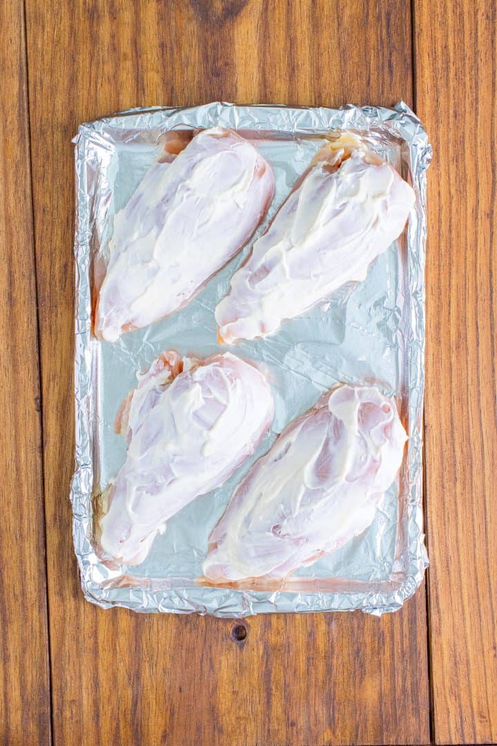 mayonnaise spread evenly on top of each chicken breast.