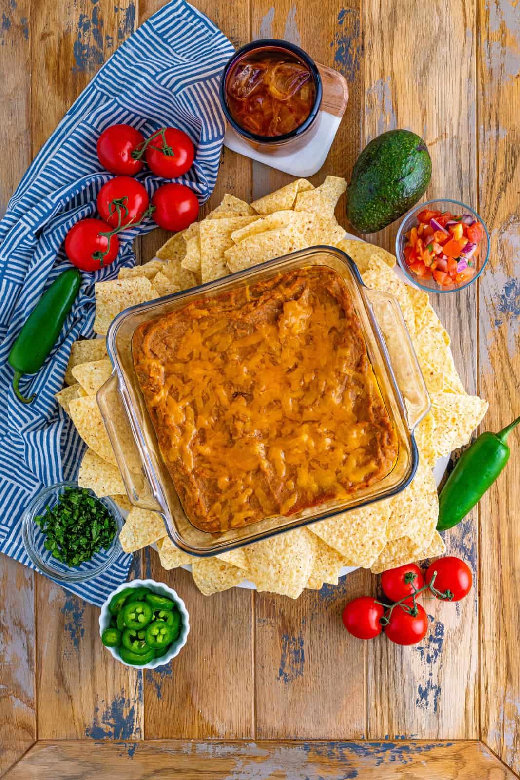 fully baked refried bean dip surrounded by tortilla chips.