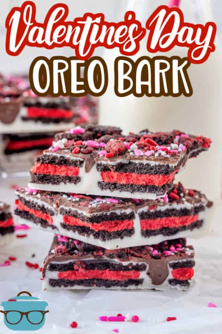 Valentine's Day Oreo Bark Recipe from The Country Cook, pictured are 3 pieces of Oreo cookie bark stacked on top of each other with a small glass bottle of milk in the background.