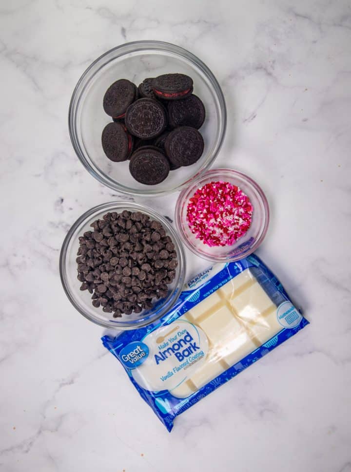 Oreo Bark ingredients: Oreo cookies, sprinkles, white chocolate, almond bark, chocolate chips.