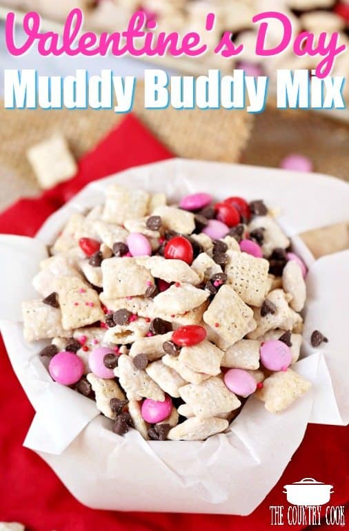overhead photo of valentines day muddy buddies in a parchment paper lined bowl.