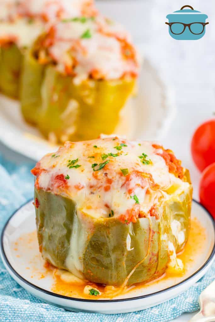 close up image of stuffed peppers with melted cheese on a small round plate