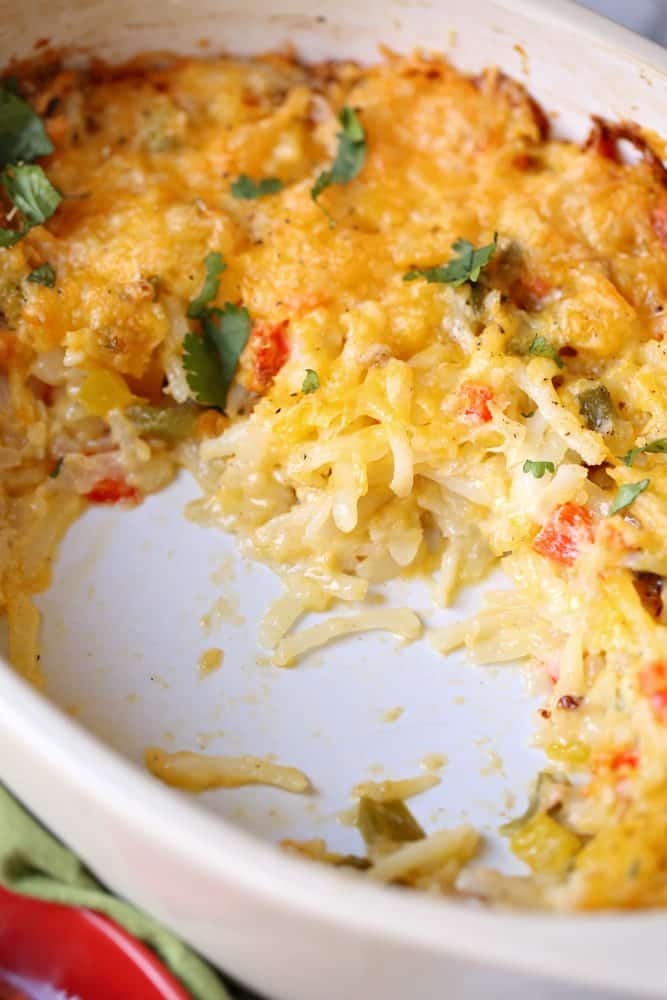 Tex-Mex hash brown casserole cooked in an oval white baking dish