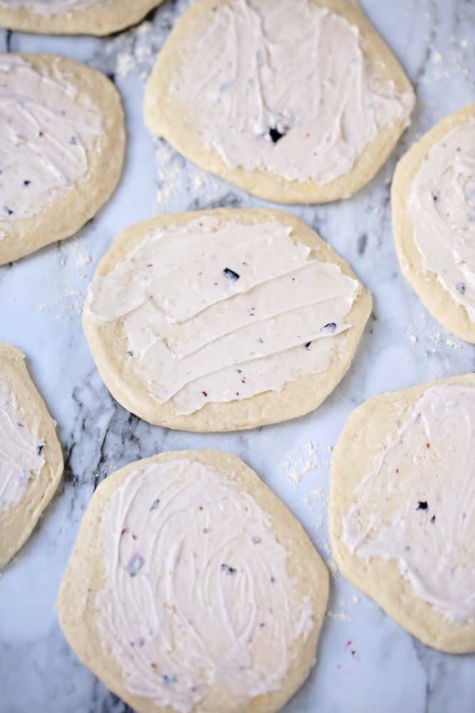 blueberry cream cheese spread on flattened refrigerated biscuits.