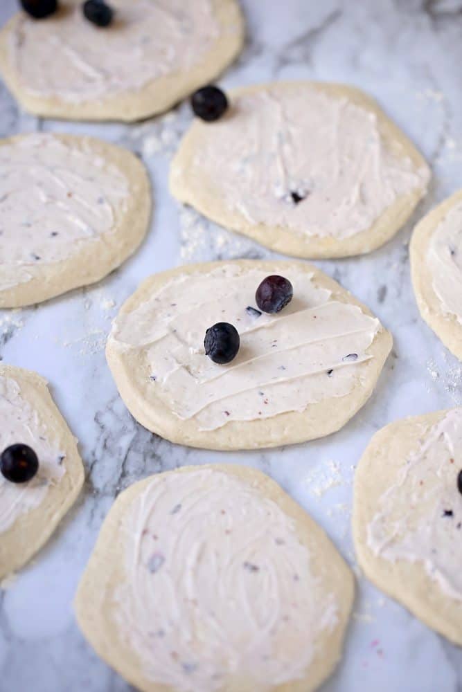 fre4sh blueberries on top of blueberry cream cheese spread on refrigerated biscuits.