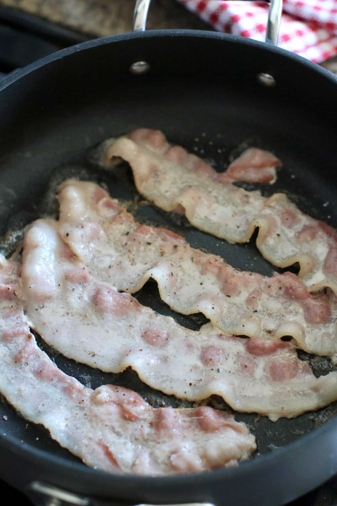 cooking bacon in a skillet.