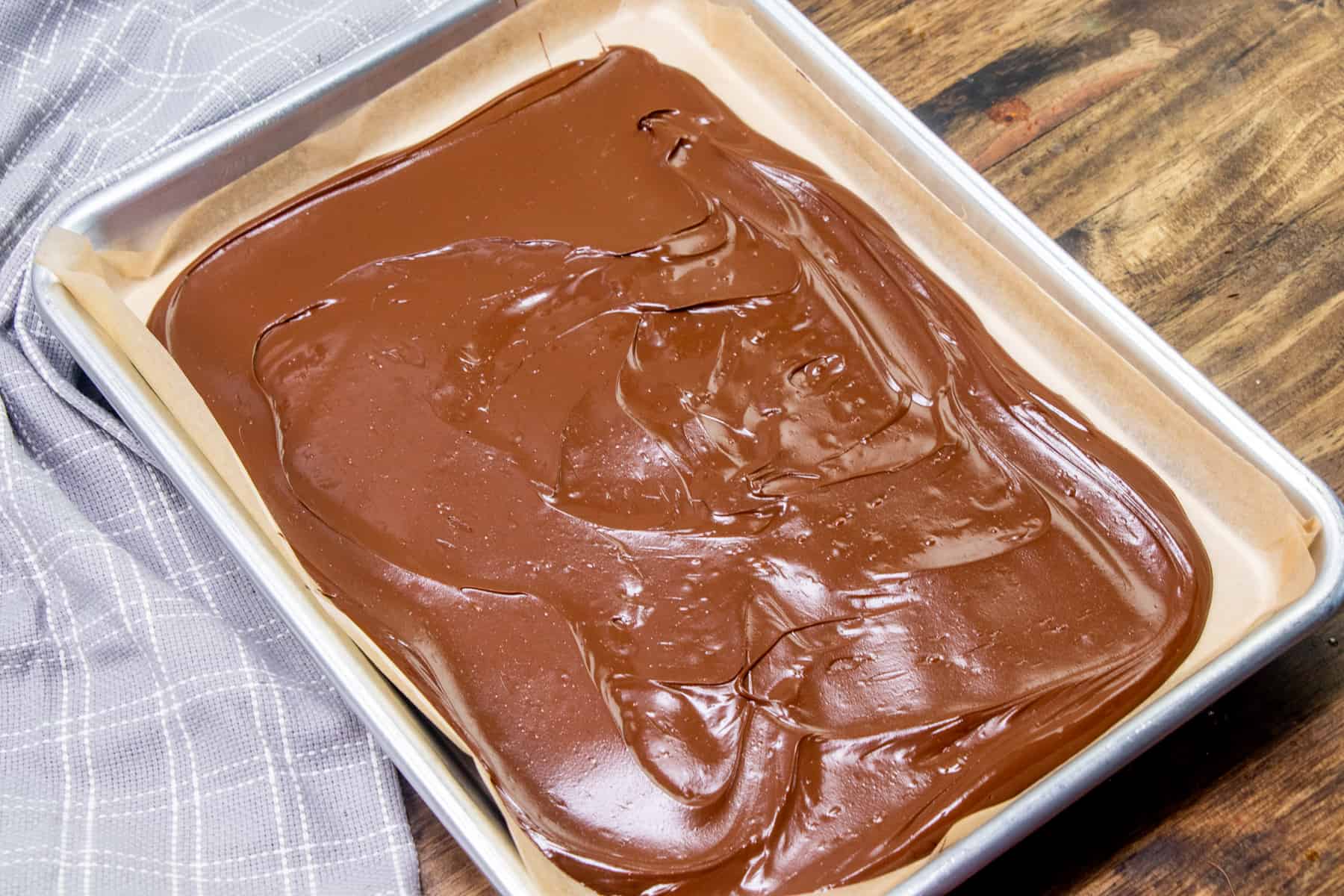 melted chocolate spread out onto parchment paper.