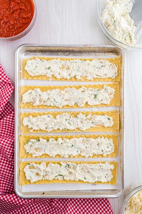 ricotta cheese mixture spread into the middle of all the lasagna noodles.