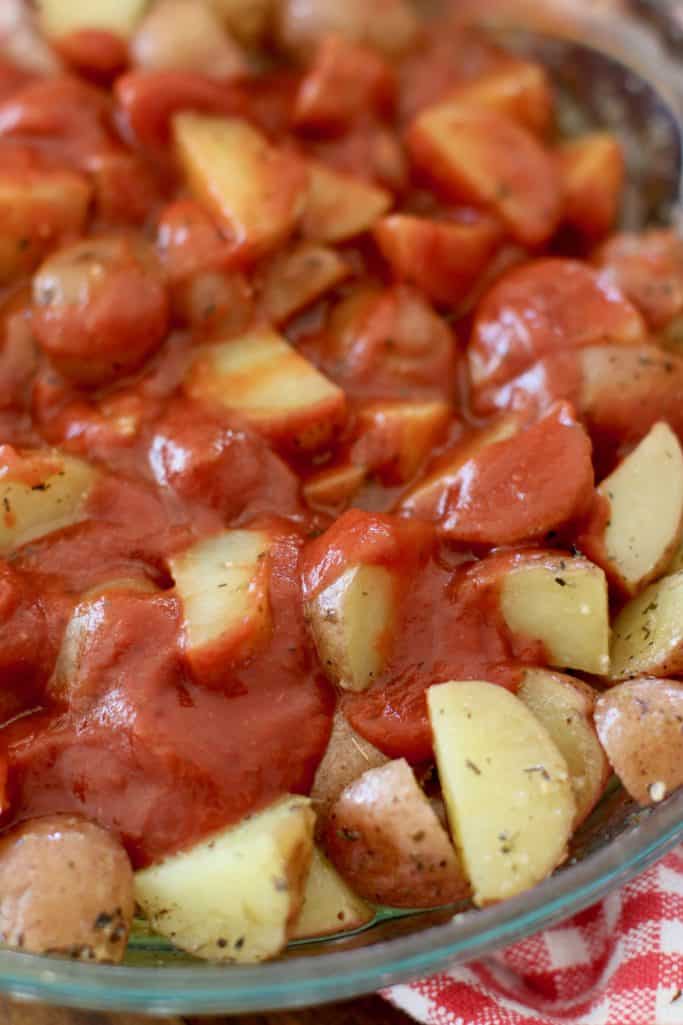pizza sauce on cooked, diced potatoes