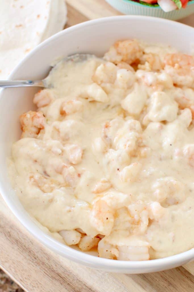 cheese sauce added to cooked shrimp