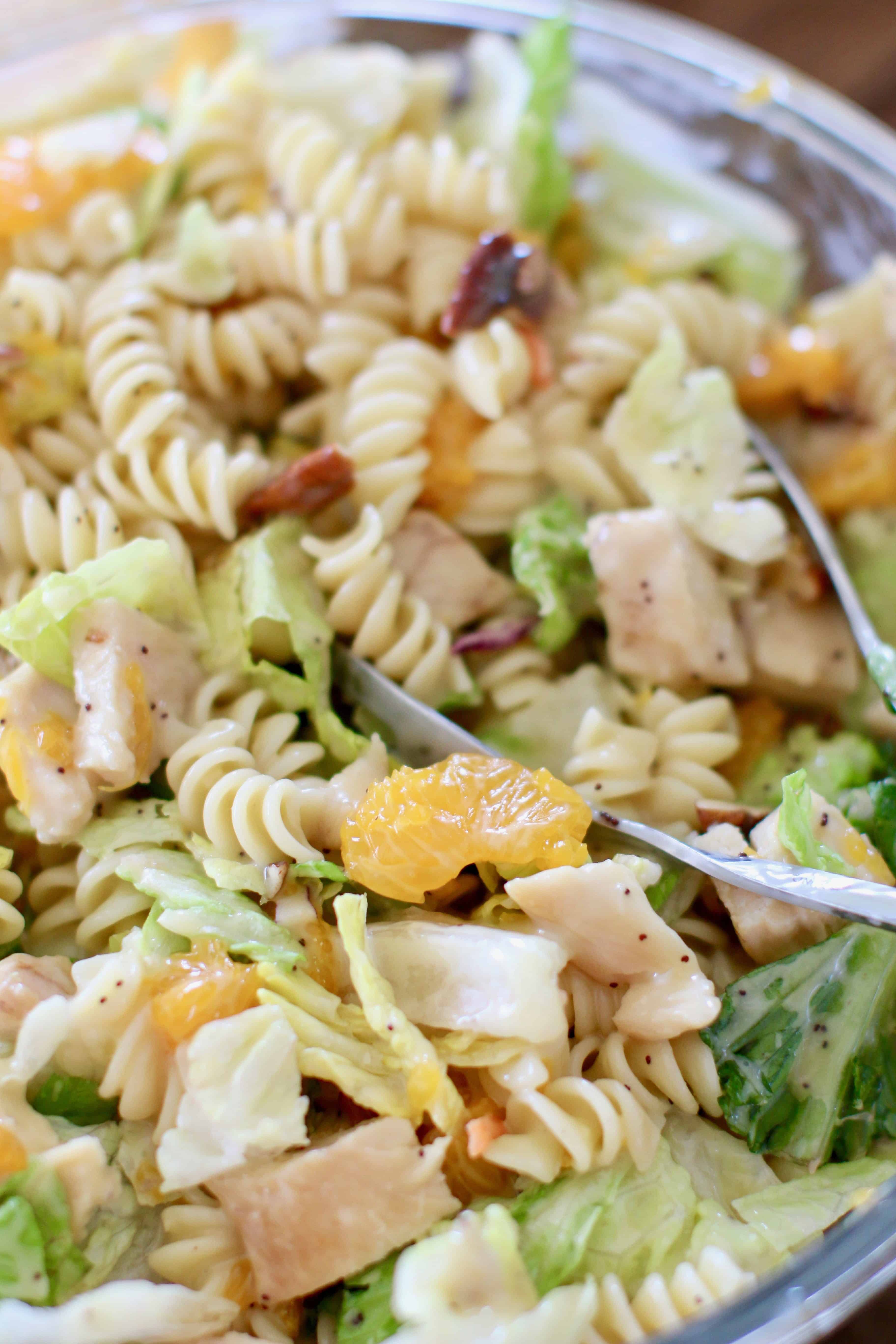 pasta stirred together with lettuce, mandarin oranges, grilled chicken and poppyseed dressing.