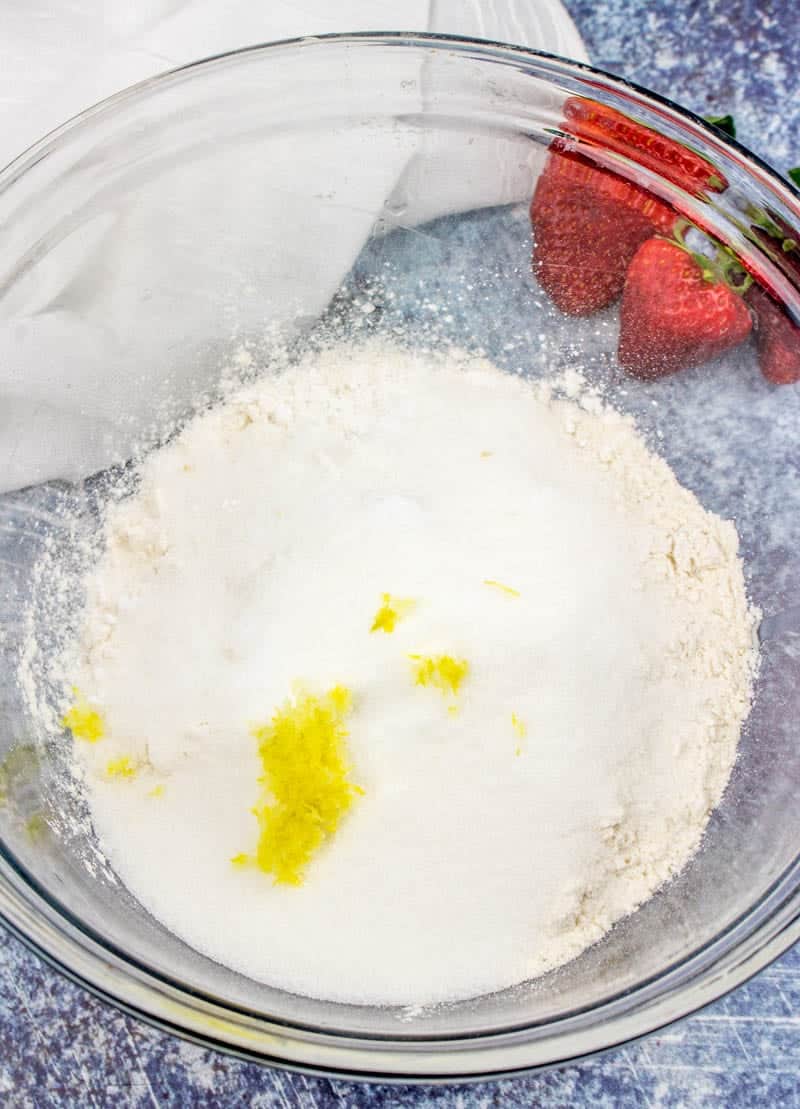 flour sugar, baking soda, lemon zest in a bowl.