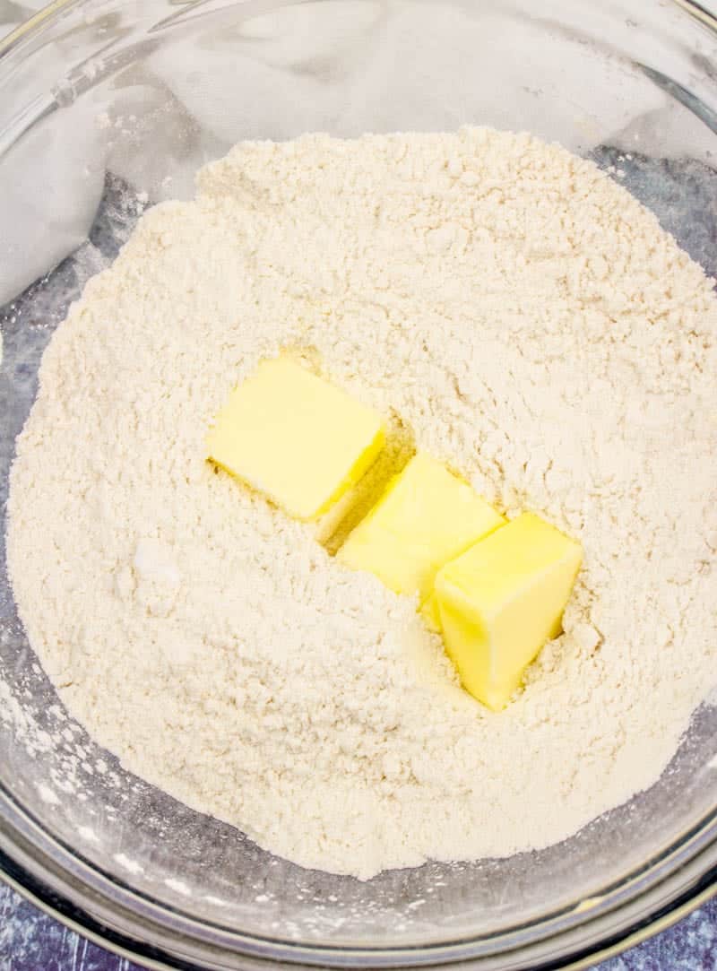 cold butter added to all purpose flour and sugar in bowl