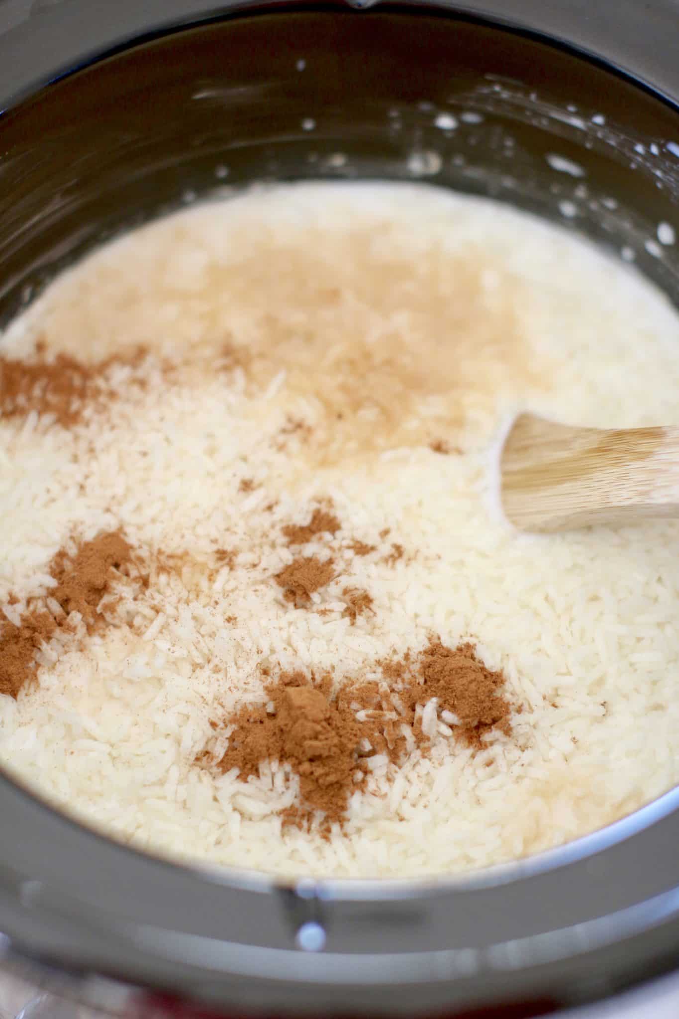 seasoning rice pudding mixture with ground cinnamon and vanilla extract.