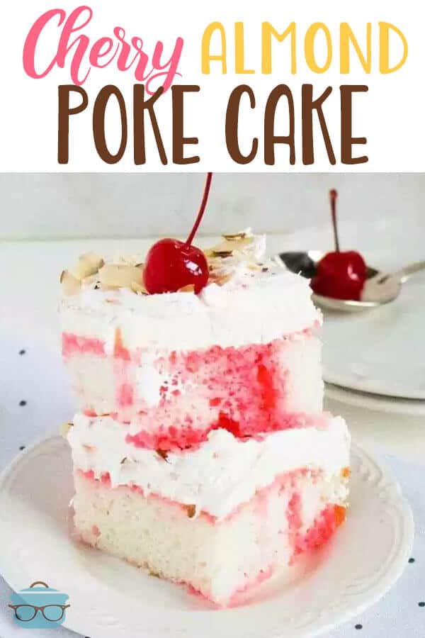 two slices of cherry almond poke cake stacked on top of each other on a white plate. 