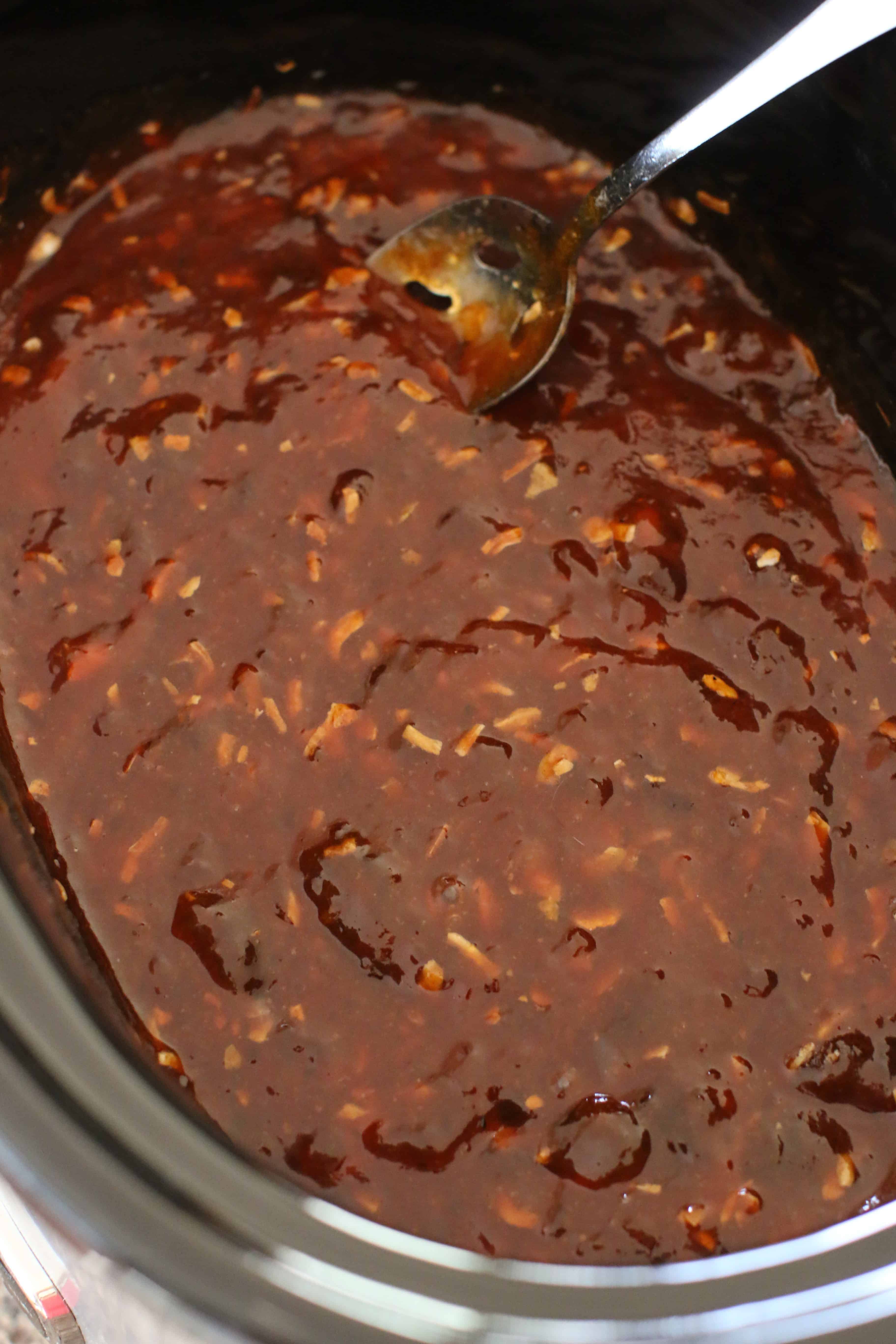 BBQ sauce, apricot jam and onion soup mix stirred together in a KitchenAid 5 quart crock pot.