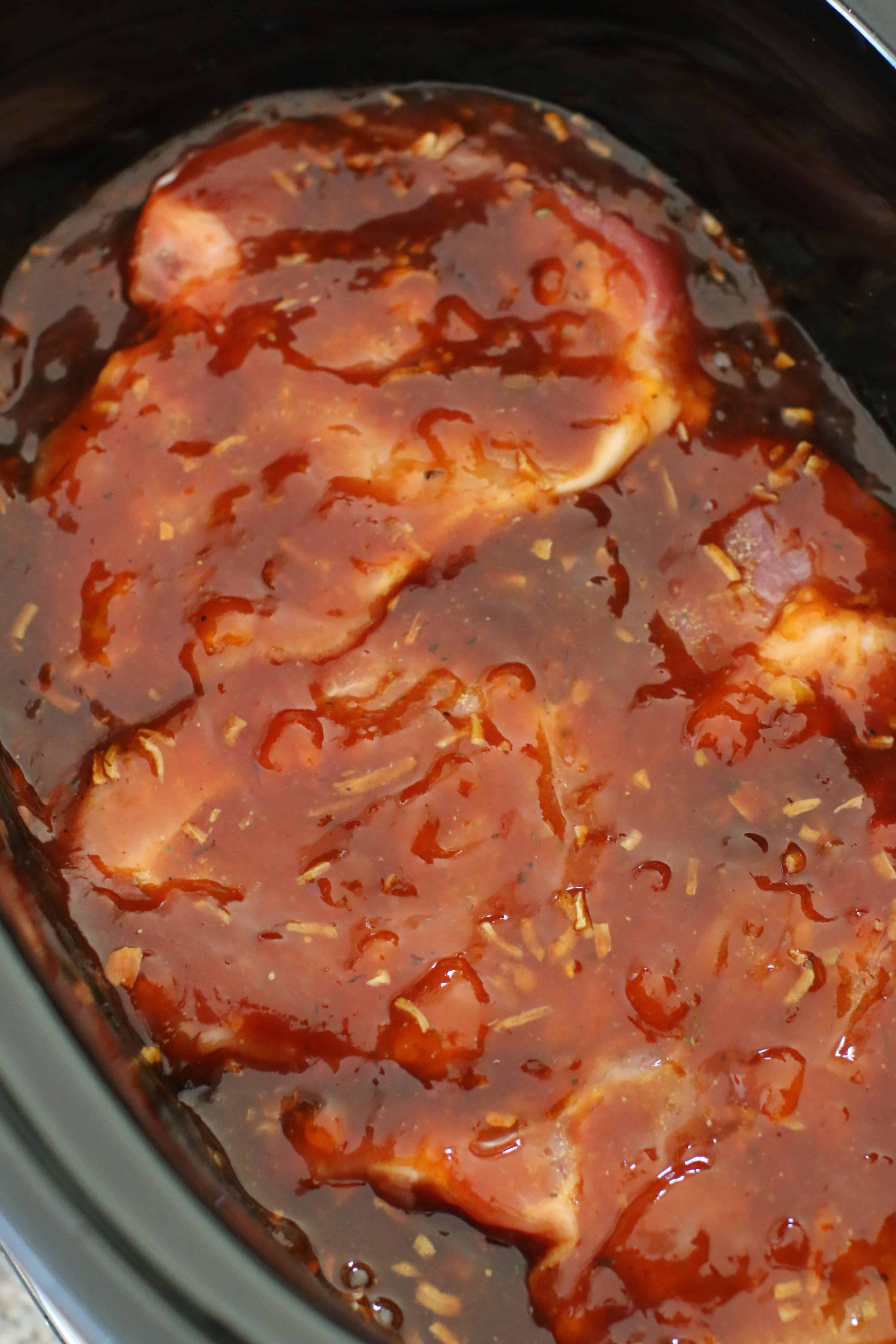 pork chops in barbecue sauce in crock pot.