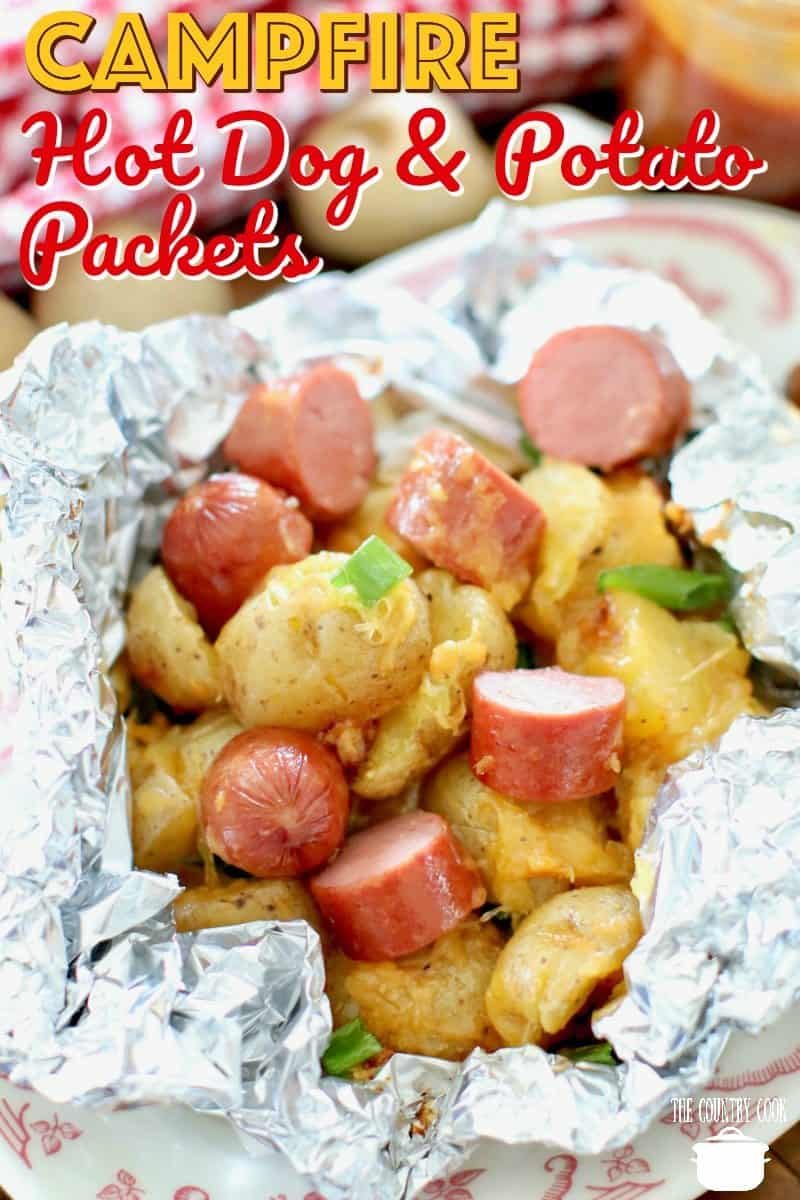 sliced hot dogs over sliced potatoes in wrapped aluminum foil.