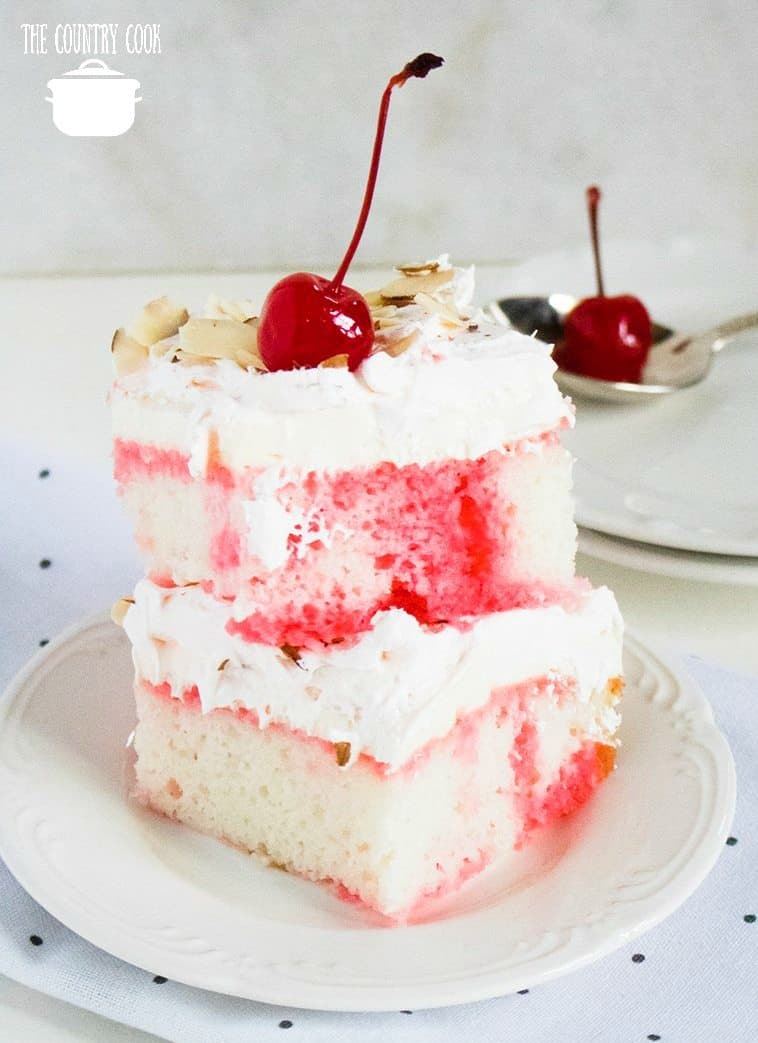 Cherry Almond Poke Cake recipe, slices stacked on a white plate.